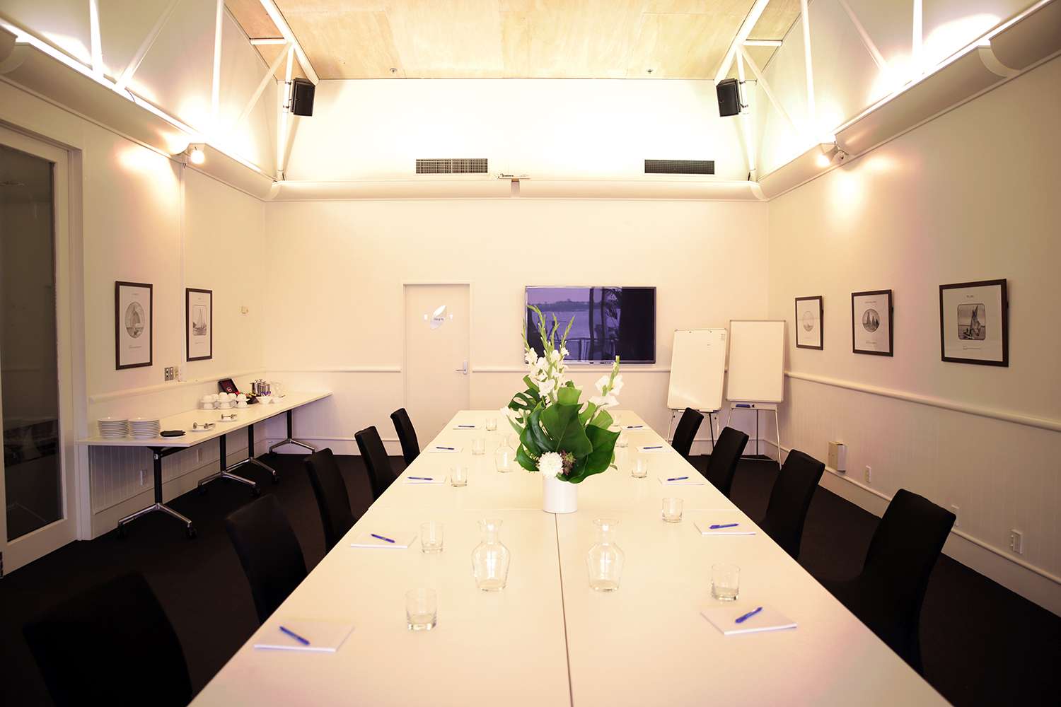 Conference room with presentation screen and seating Conference room with presentation screen and seating